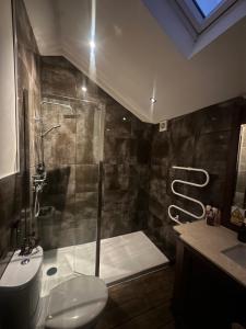 ein Badezimmer mit Dusche, Toilette und Waschbecken in der Unterkunft Meagill Cottage Sleeps 4 with Hot Tub & Parking in Otley