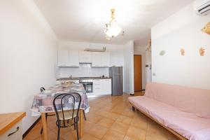 a living room with a table and a couch at Colle di Rio - Goelba in Rio nellʼElba