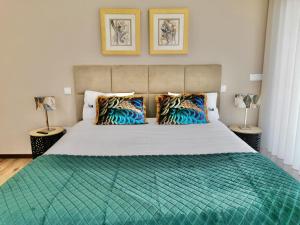 a bedroom with a large bed with a green comforter at Villa Recanto de Fornelos, Gerês - Até 10 Pax in Geres +60 photos