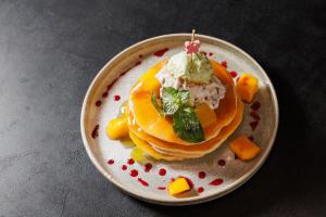 a plate of food with a stack of pancakes at City Premium Heritage in Zadar