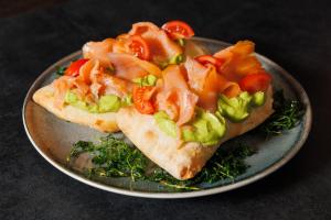 a plate with two slices of bread with tomatoes and lettuce at City Premium Heritage in Zadar