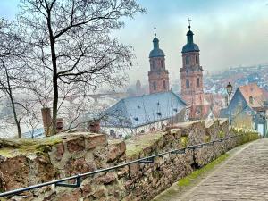 a city with two towers and a stone wall at Altes Dichterhaus von 1859 in Miltenberg