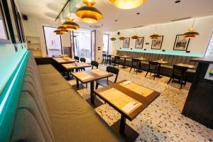 a restaurant with tables and chairs and a couch at City Premium Heritage in Zadar
