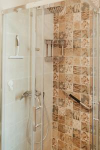 a bathroom with a shower with a glass door at Apartment Aria 2 in Velingrad +13 photos