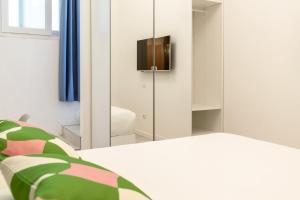 a bedroom with a bed and a mirror at Ravebility - self check-in in Quartu SantʼElena