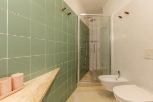 a bathroom with a shower and a toilet and a sink at Ravebility - self check-in in Quartu SantʼElena