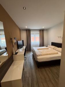 a bedroom with a large bed and a desk at Austria Traveller Hotel Kirchdorf in Kirchdorf an der Krems