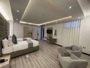 a large hotel room with a bed and a desk at Hammer Luxury Guesthouse in Addis Ababa