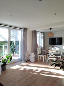 a living room with a large window and a table at Ferienwohnung zur alten Post in Pirna
