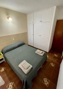 a bedroom with a bed with two towels on it at Costa Clara Hotel in Santa Clara del Mar