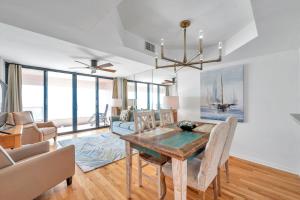 a dining room with a table and a couch at Crescent Beach Club 19C in Clearwater Beach