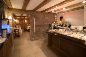 a restaurant with a buffet line with a table at Hotel Etol - Superior in Baden-Baden