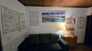 a living room with a couch and a table at Hospetur 2 in Horta