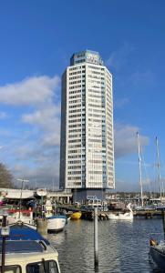 a tall building with boats docked in a harbor at Schleiblick in Schleswig