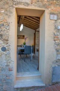a dining room with a table in a stone building at appartamento l'olivo in San Gimignano +4 photos