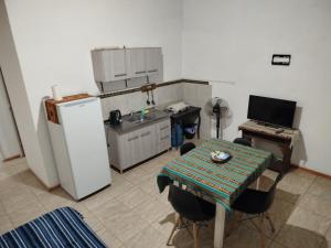 Villa Ciudad ParqueにあるCabaña los cuatesのテーブルと冷蔵庫のある小さなキッチン +5枚の写真