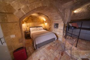 Ένα ή περισσότερα κρεβάτια σε δωμάτιο στο Suite San Biagio nei sassi