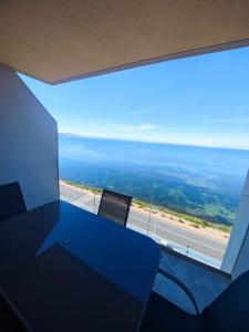 a room with a blue table and a view of a highway at Apartamento BLUE LAGUNA Playa Principe La Manga in La Manga del Mar Menor