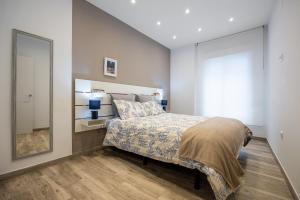a bedroom with a bed and a large mirror at Oviedo Puerto in Fuengirola