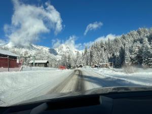 a view of a snow covered road from a car at Andys Secret Apartment in Leutasch +9 photos