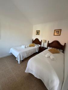 a hotel room with two beds with white sheets at Quinta do Cutato - Piscina Guest House in Santo Estêvão