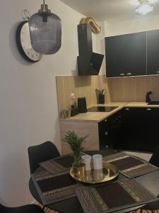 a kitchen with a table with a clock on the wall at Apartman Pinea in Samobor +9 photos