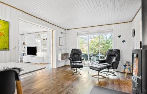 a living room with two chairs and a table at 4 Bedroom Beautiful Home In Skjern in Skjern