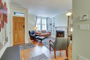 a living room with a couch and chairs and a fireplace at Walk to Old Town Chic Alexandria Abode with Patio! in Alexandria