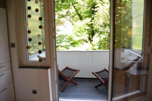 an open door to a balcony with two chairs at Apartment Hannover Top Citylage in Hannover