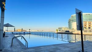 a view of a body of water with buildings at Oceanview 2BR Bliss in Al Raha - Pool & Balcony Near Al Raha Beach in Abu Dhabi