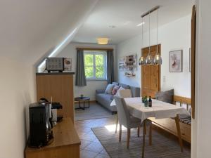 a living room with a table and a couch at Landhaus Rossatz in Rossatz