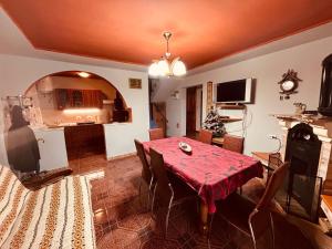 a living room with a table and a kitchen at ViiLa Cabanuta in Filia