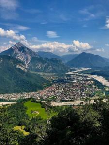 an aerial view of a city with mountains in the background at Casa Gugjet Cuore Carnico - appartamento Zoncolan - giardino - no scale - parcheggio e 4 zampe gratis in Arta Terme