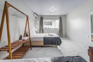 En eller flere senge i et værelse på RUC - Casas a 270m da Praia do Canto Grande