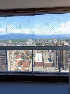 a view of a city from a window at Residencial Acquamare in Praia Grande