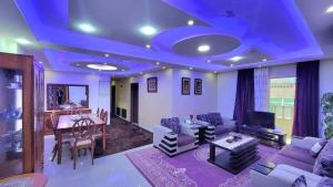 a large living room with a blue ceiling at water house in Al Quwaysimah