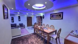 a dining room with a wooden table and chairs at water house in Al Quwaysimah +18 photos