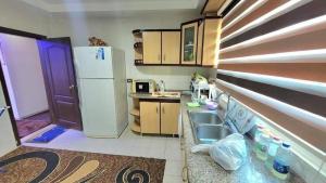 a kitchen with a sink and a refrigerator at water house in Al Quwaysimah