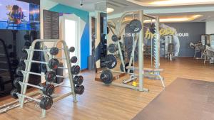a gym with a lot of equipment in a room at Oceanview 2BR Bliss in Al Raha - Pool & Balcony Near Al Raha Beach in Abu Dhabi