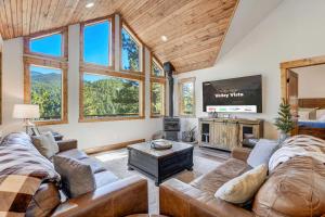 a living room with a couch and a tv at Valley Vista Lodge Hot Tub Shuffleboard Darts BBQ in Midland