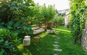a garden with a bench and trees in the grass at Nice Apartment In Casal Velino in Casal Velino