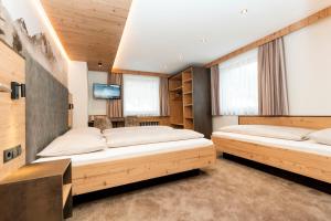 Postel nebo postele na pokoji v ubytování Hotel Garni Pfeifer