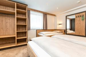 Postel nebo postele na pokoji v ubytování Hotel Garni Pfeifer