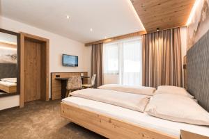 Postel nebo postele na pokoji v ubytování Hotel Garni Pfeifer