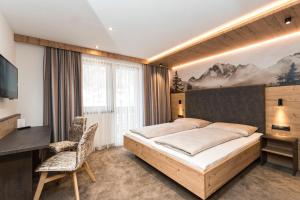 Postel nebo postele na pokoji v ubytování Hotel Garni Pfeifer