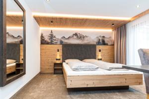 Postel nebo postele na pokoji v ubytování Hotel Garni Pfeifer