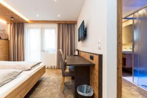Postel nebo postele na pokoji v ubytování Hotel Garni Pfeifer