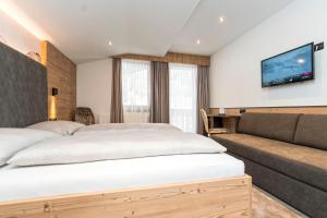 Postel nebo postele na pokoji v ubytování Hotel Garni Pfeifer
