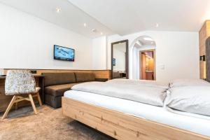Postel nebo postele na pokoji v ubytování Hotel Garni Pfeifer