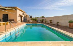 a swimming pool in front of a house at Amazing Home In La Barca De La Florida in La Barca de la Florida +15 photos